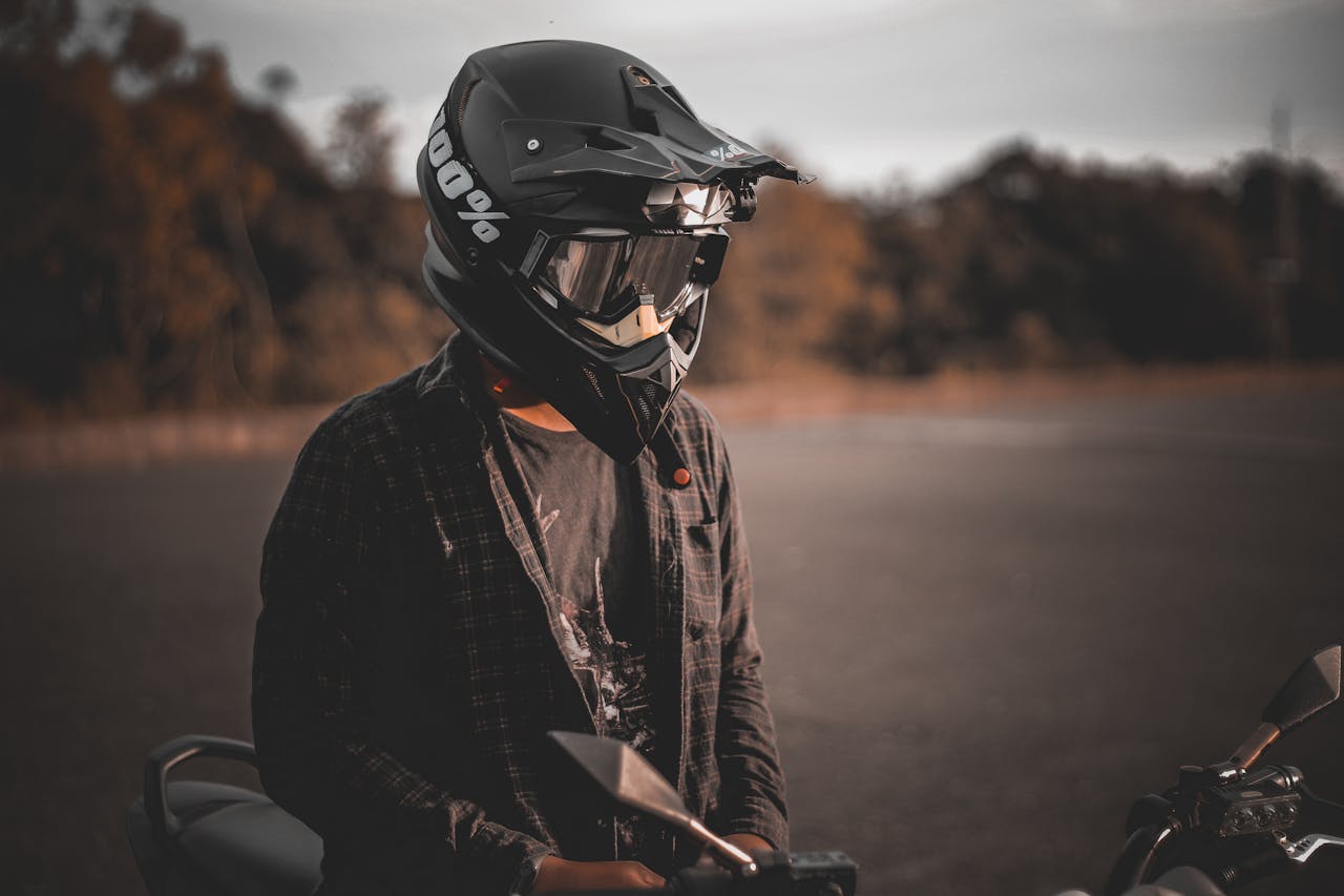 Crafting Captivating Headlines: Your awesome post title goes here Motorcyclist wearing full-face helmet, enjoying a scenic outdoor ride at sunset.