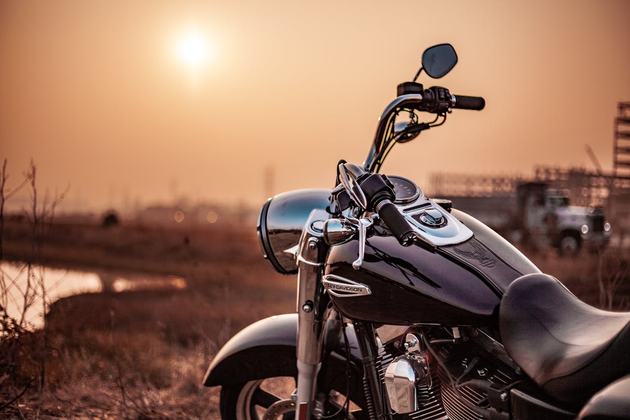 Crafting Captivating Headlines: Your awesome post title goes here Harley Davidson motorcycle parked outdoors at sunset, capturing the warm glow and serene environment.