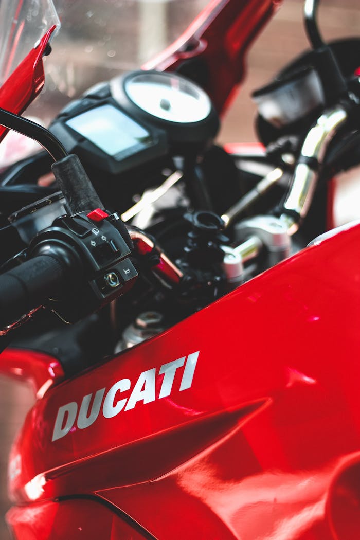 Mastering the First Impression: Your intriguing post title goes here A detailed view of a red Ducati motorcycle dashboard and handlebars.