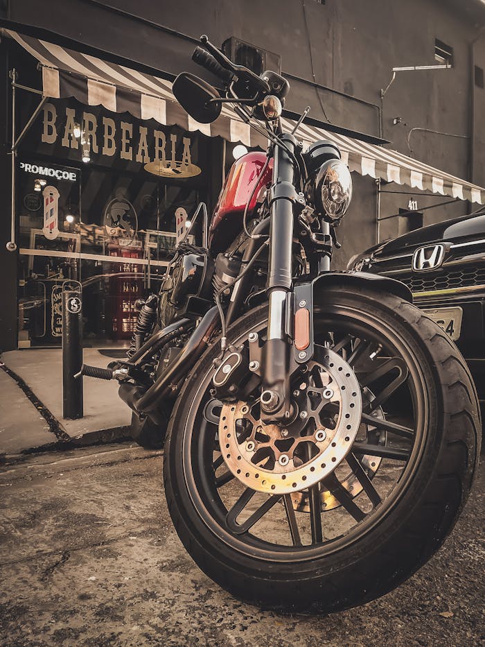 The Art of Drawing Readers In: Your attractive post title goes here A stylish vintage motorcycle parked outside a classic barbershop with a rustic ambiance.